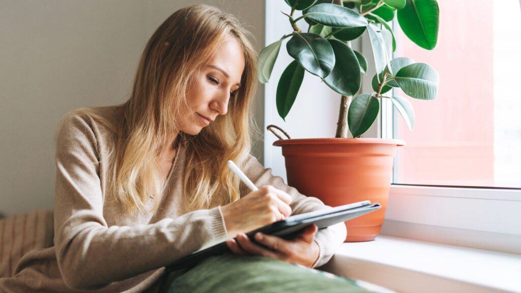 blonde haired woman drawing on the best drawing tablet for artists