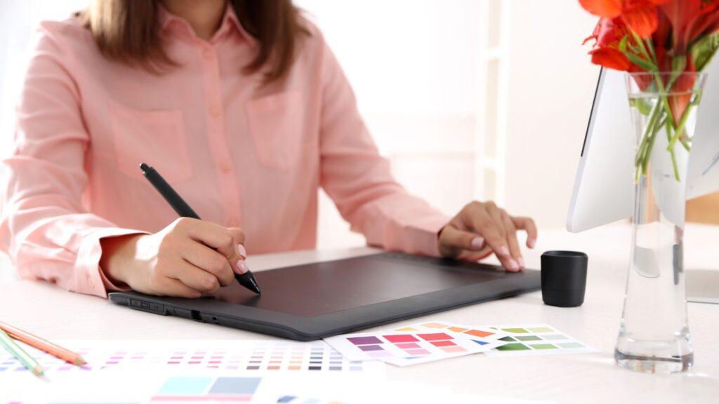 woman using drawing tablet with color palettes