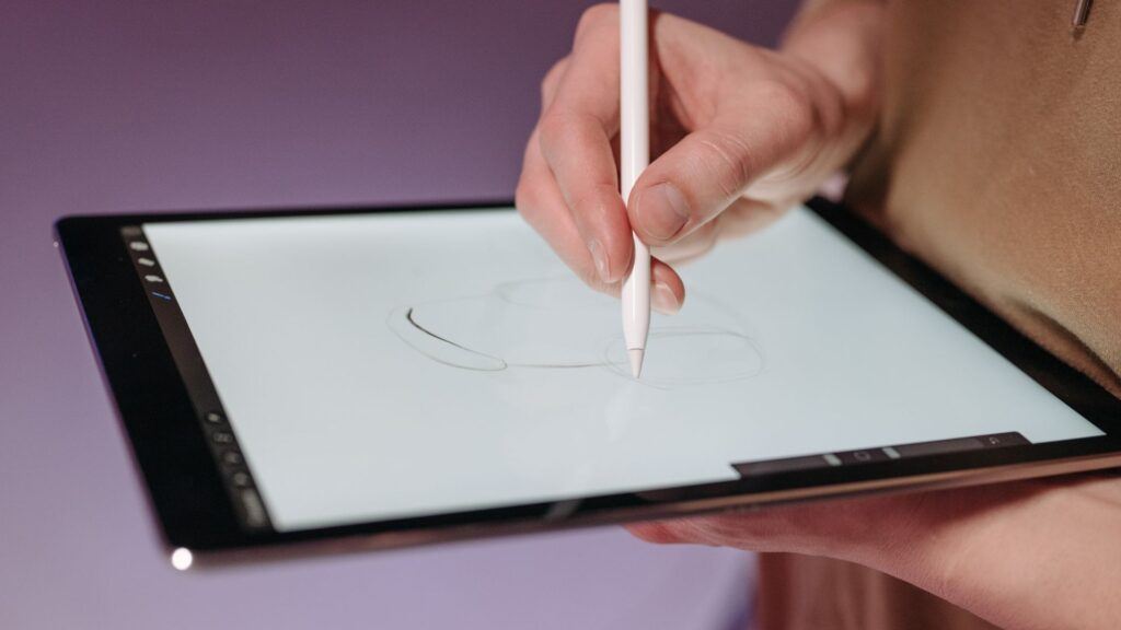 person drawing with apple pencil