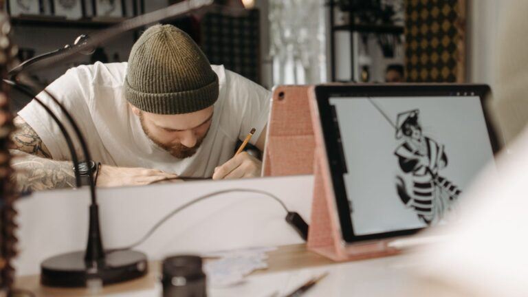 male artist drawing on tablet