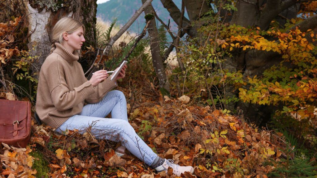 woman drawing on tablet outside