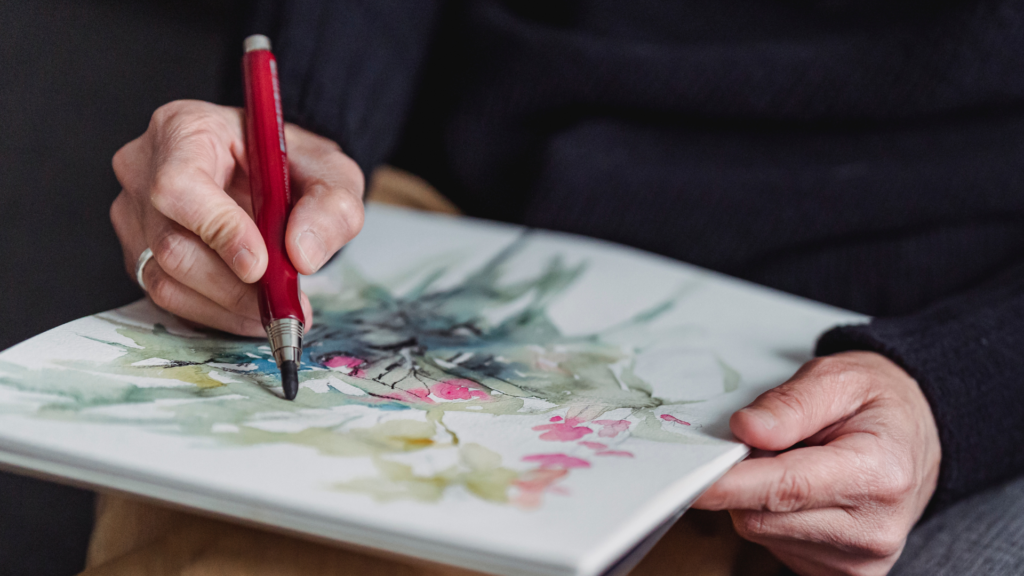 artist drawing on paper with colored pencil in how to draw for beginners